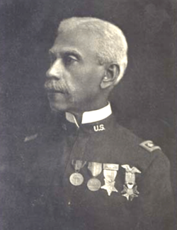 A black and white photo of Colonel Allen Allensworth in military uniform, circa 1900.