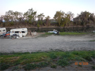 Tarps, tents, and debris of homeless encampment along the Smith Canal edge - Date of 03.11.2020 shows at the bottom of the photo