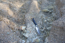 Mine waste exposed in erosion rill