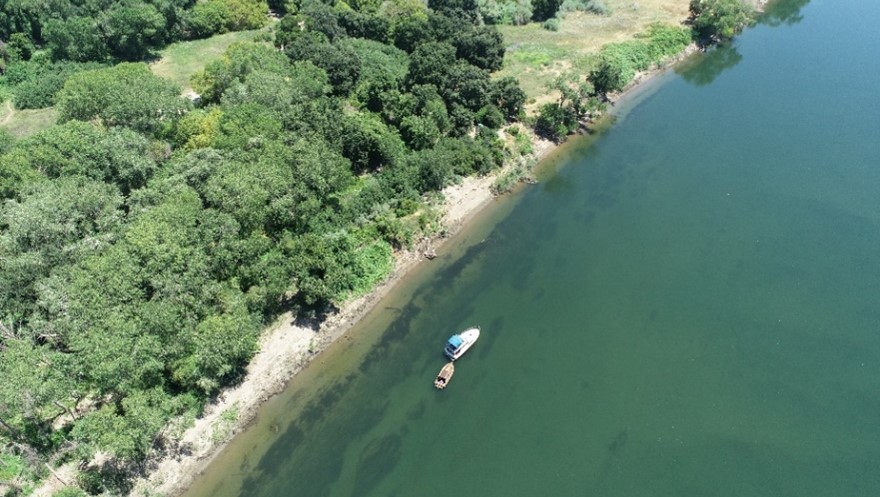 aerial view of lower american river with boats in water next to shore