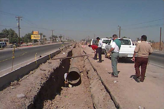 workers looking at force main