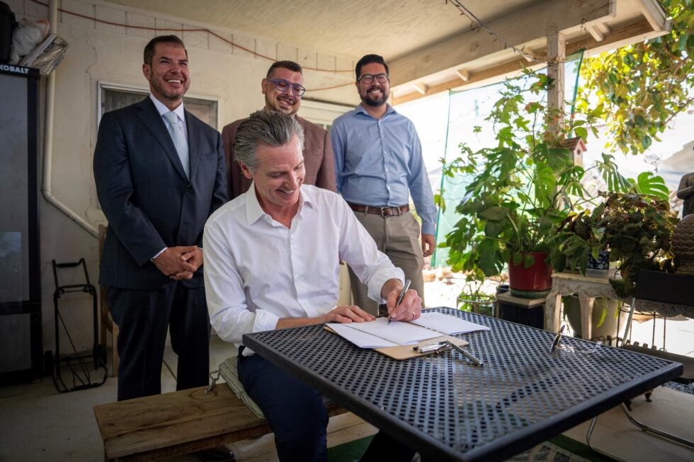 Gov. Newsom (center) signed AB 805 in September 2024 during a ceremony in East Orosi. Also pictured (left to right) Assemblyman Dr. Joaquin Arambula / Tulare County Supervisor Eddie Valero / State Water Board Chair E. Joaquin Esquivel.