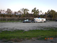 Peering through chain link fence of water edge showing debris in the Smith Canal - Date of 03.11.2020 shows at the bottom of the photo