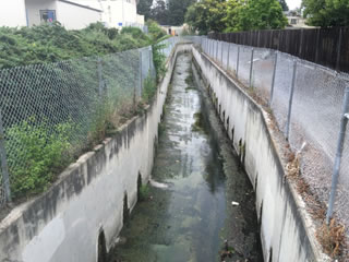 Photo showing Permanente Creek near Crittenden Middle School in Mountain View. This is also a bottom of the watershed photo where the creek is confined to a narrow concrete channel.
