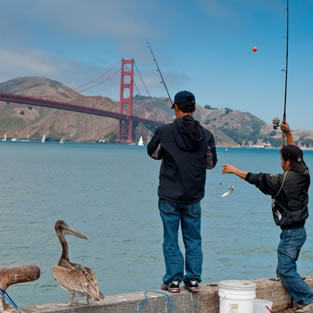 People fishing from Pier with Golden Gate Bridge in background