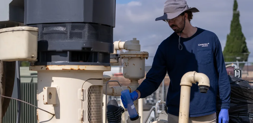A scientist taking a water sample from a well in California